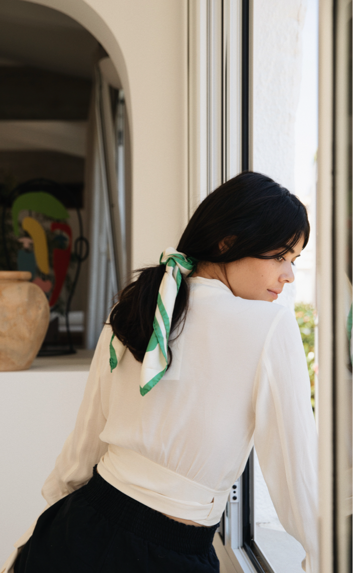 Woman with BEMBIEN Delfina Scarf in Green in hair looking out the window