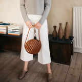Bembien Audrey Bag in Sienna held in the hands of a standing person