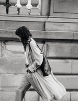 Bembien Jeanne Bag on the shoulder of a woman walking - black and white photograph