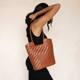 Bembien Camilla Bag in Sienna on the shoulder of a standing woman grabbing her hair