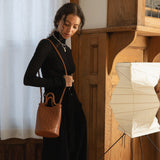 Bembien Lina Bucket in Sienna worn as a shoulder bag by a woman