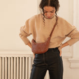 Bembien Mini Sling in Sienna worn on a woman as a crossbody bag