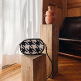 Bembien Ovale Crossbody in White/Black Houndstooth shown on a pedestal