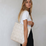 Bembien Le Tote Grande Weave in Cream worn on the shoulder of a standing woman