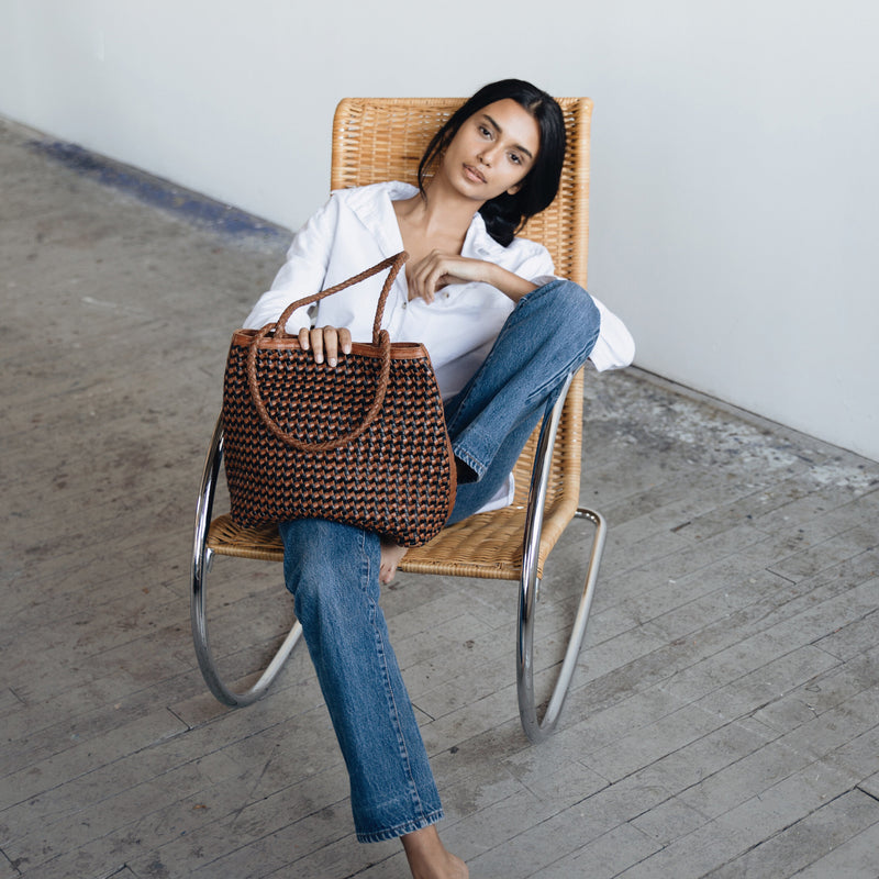 Bembien Olivia Tote in Black/Sienna Two Tone in the lap of a seated woman