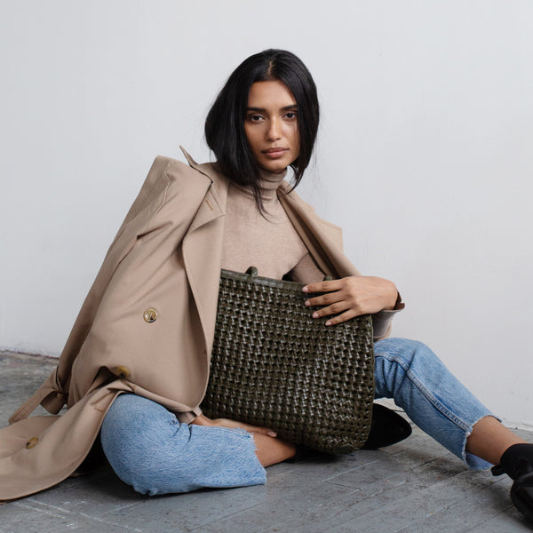 Bembien Olivia Tote in Olive held by a seated woman