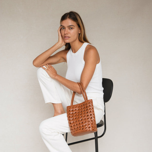 Bembien Bonita Bag Oversized Knot in Sienna worn by a seated woman