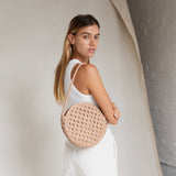 Bembien Audrey Bag Oversized Knot in Caramel worn by a standing woman